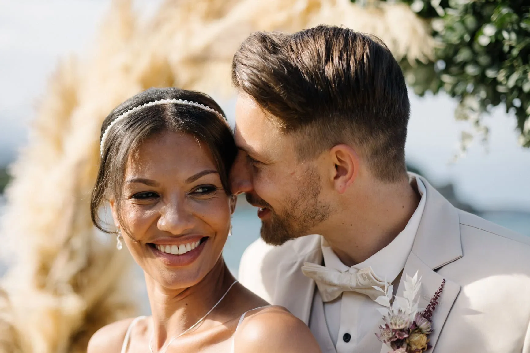 Bride laughing with joy beside the groom at their pampas-decorated ceremony
